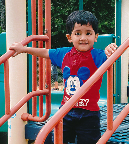 Young boy on playground equipment